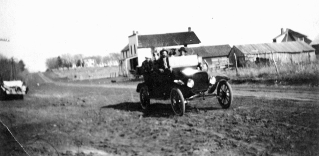 A touring car passes through Keene, Kansas on Kansas Highway 4 in this photo circa, 1920. Photo Courtesy Ida Thomas.