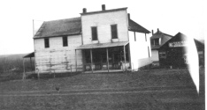 The Keene Store opened at the intersection of K-4 Highway and Bradford Road in 1874. Notice in this view that when this photo was taken the store was two stories and had full storefront on the east side of the building as well as the north side. An early blacksmith shop is visible at the right. When this photo was taken, the road was still mud and the store had no gas pumps. Photo Courtesy Ida Thomas.