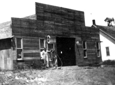 An unidentified an stands in front of the blacksmith shop at Keene, Kansas in this view, circa 1920. Notice that the Keene School is visible to the right, located quite near the blacksmith shop. Both buildings were located at the intersection of K-4 Highway and Missile Base Road.