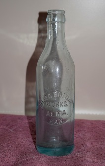 This crown-top pop bottle from the Alma Bottling Works, Alma, Kansas is on display at the Wabaunsee County Historical Society Museum in Alma, Kansas.