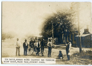 A group of Alma men pose for Gus Meier's camera in front of Froshien Hall, a saloon located on East 3rd Street in Alma. The small building at the far right was a one-lane bowling alley, while Joker Horne's "joint" was located in the second building.