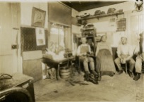 Ferdinand Herrmann, Christine Herrmann, and Fred Herrmann are seen in this Gus Meier interior view of their shoe shop in Alma, dated 1912.