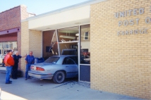 Bill Mercer, Dean Dunn, and Jack Price inspect the wreckage created when a customer of the Eskridge Post Office installed a drive-through window in the office in this view from about 2000.