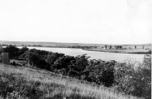 Dean Dunn took this photograph of Lake Wabaunsee from the east arm, looking to the west. The barracks buildings are visible on the north shore.