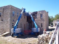 Stonemasons removed, marked and stacked, and then re-laid the original limestone of the Alma Hotel in this view dated 2010.