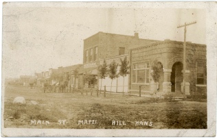This real photo postcard by Zercher, shows the west side of the 200 block of Main Street in Maple Hill, Kansas in 1909.
