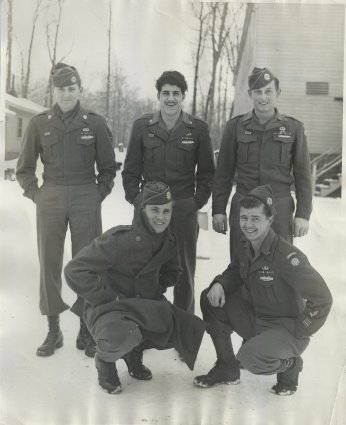 Brothers in Arms, five members of the 82nd Airborne pose for a photographer in front of a barracks building at Jefferson Barracks, at St. Louis in December of 1945. George Spartichino stands on the back row, center with Charlie Barnhart on the back row, far right. Notice the AA arm patch on the soldier squatting at the lower right. This was the insignia of the 82nd Airborne, signifying the Division's makeup of men from all 48 states, making it the truly All-American division.