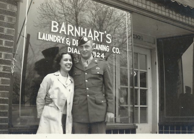In this 1946 photo, Reba and Charlie Barnhart stand in front of Barnhart's Laundry & Dry Cleaning Co, owned by Turner Barnhart and located at 110 N 9th Street in Columbia, Missouri.