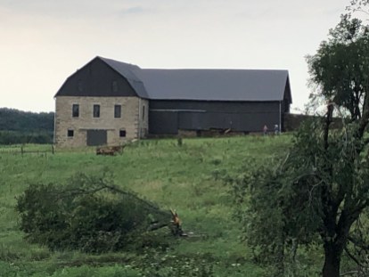 Damage from an August 15, 2019 tornado was limited to the north wall of the granary on the massive Schepp barn. (Image courtesy Abby Amick)
